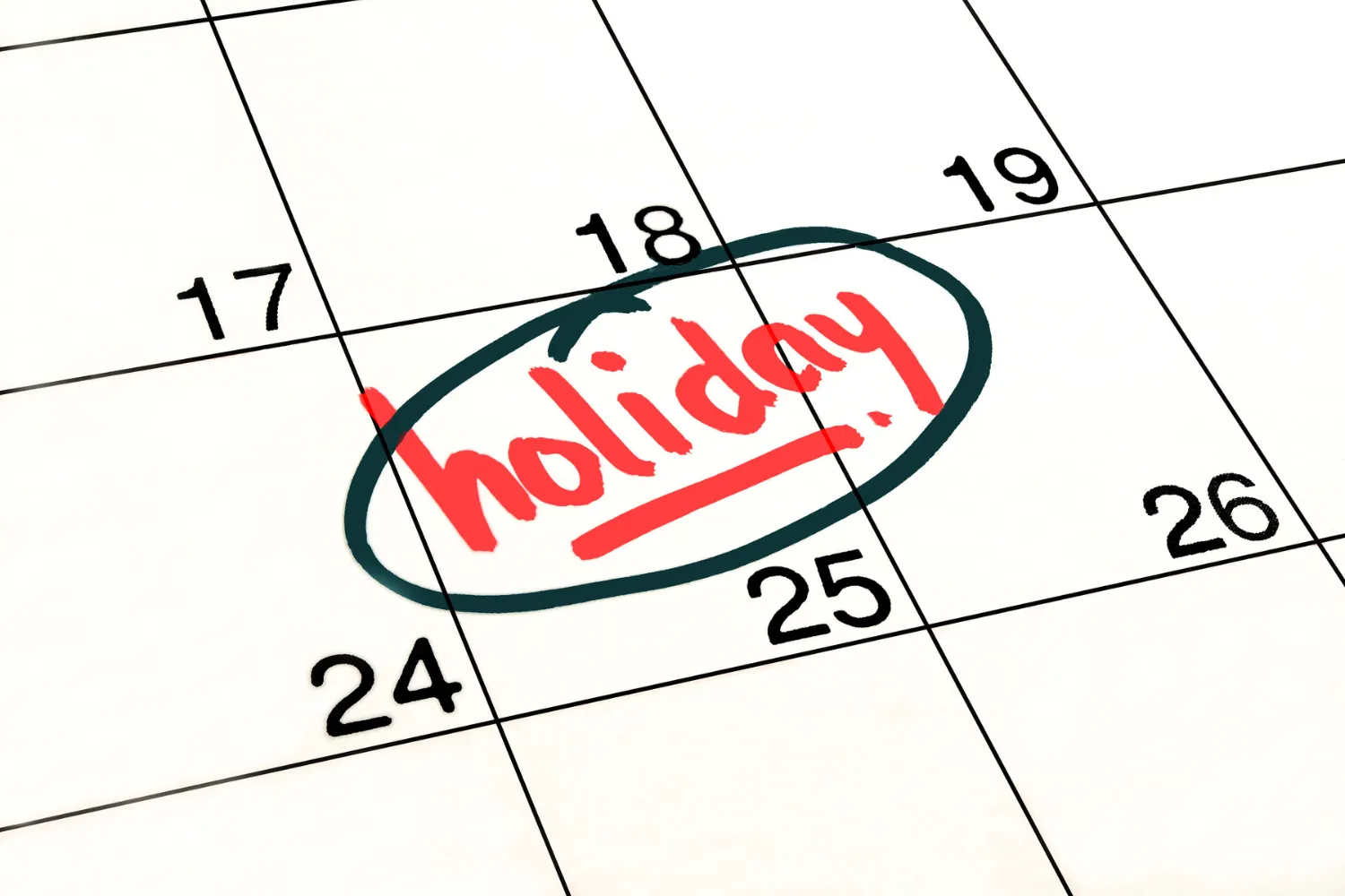 A calendar with the word "holiday" circled.