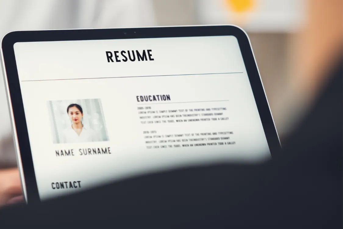 Close-up of a digital resume displayed on a laptop screen during a job application review