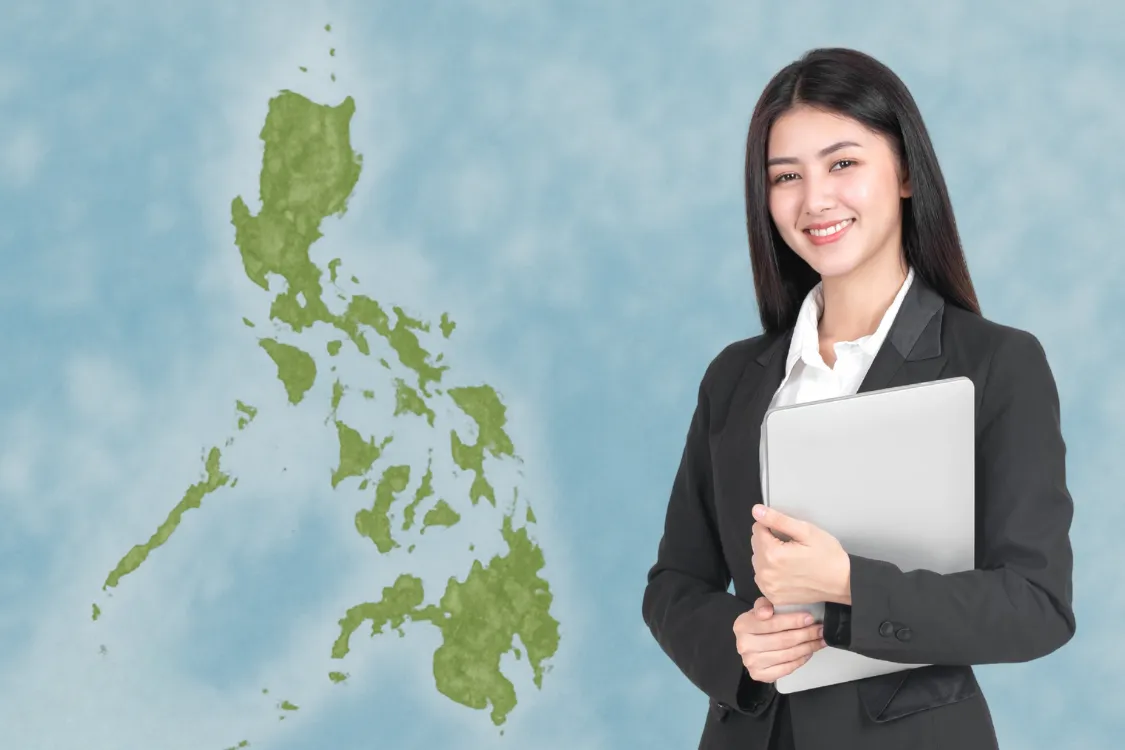 Filipino job candidate standing beside a map of the Philippines, symbolizing regional hiring insight.