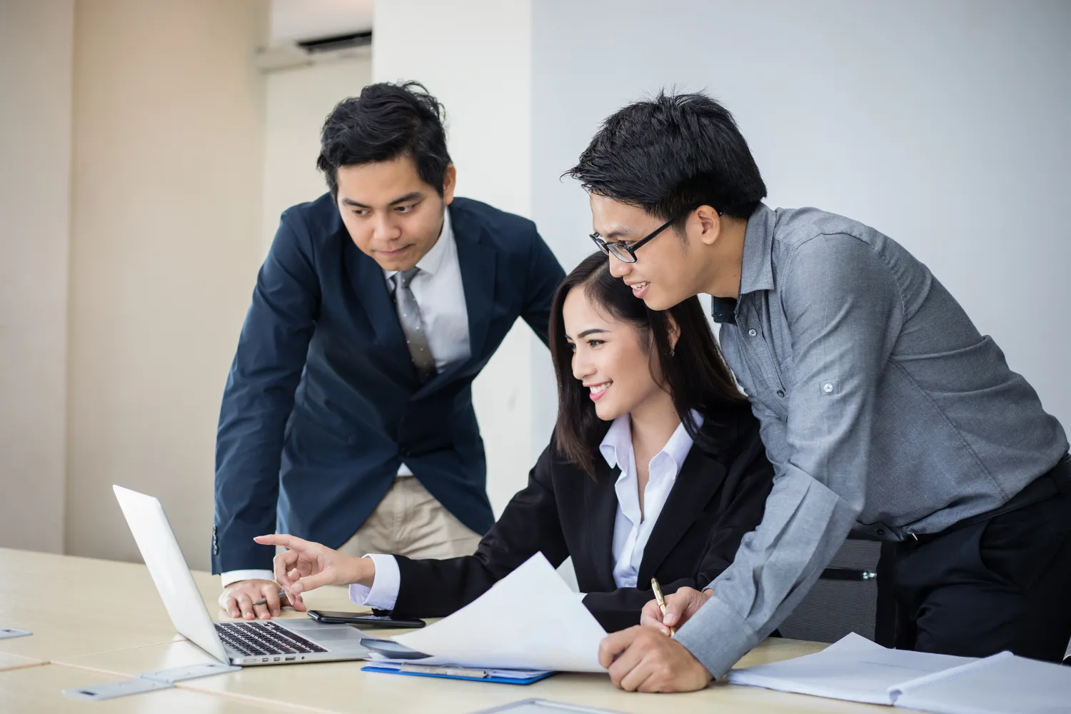 A team checking something on a laptop.