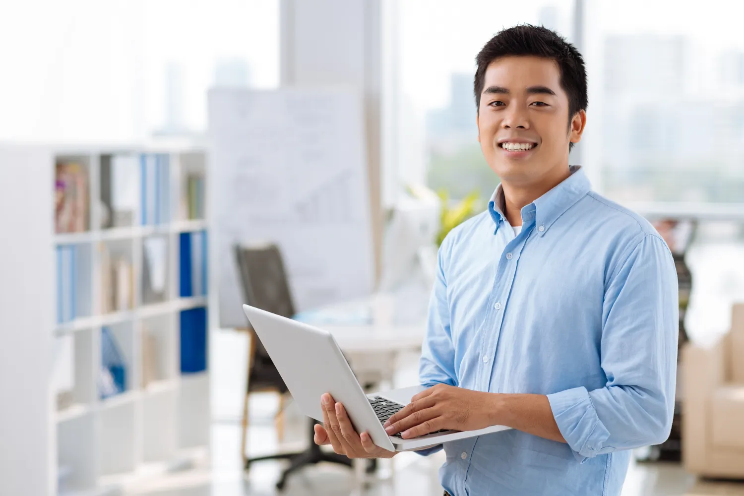 A professional holding his laptop.