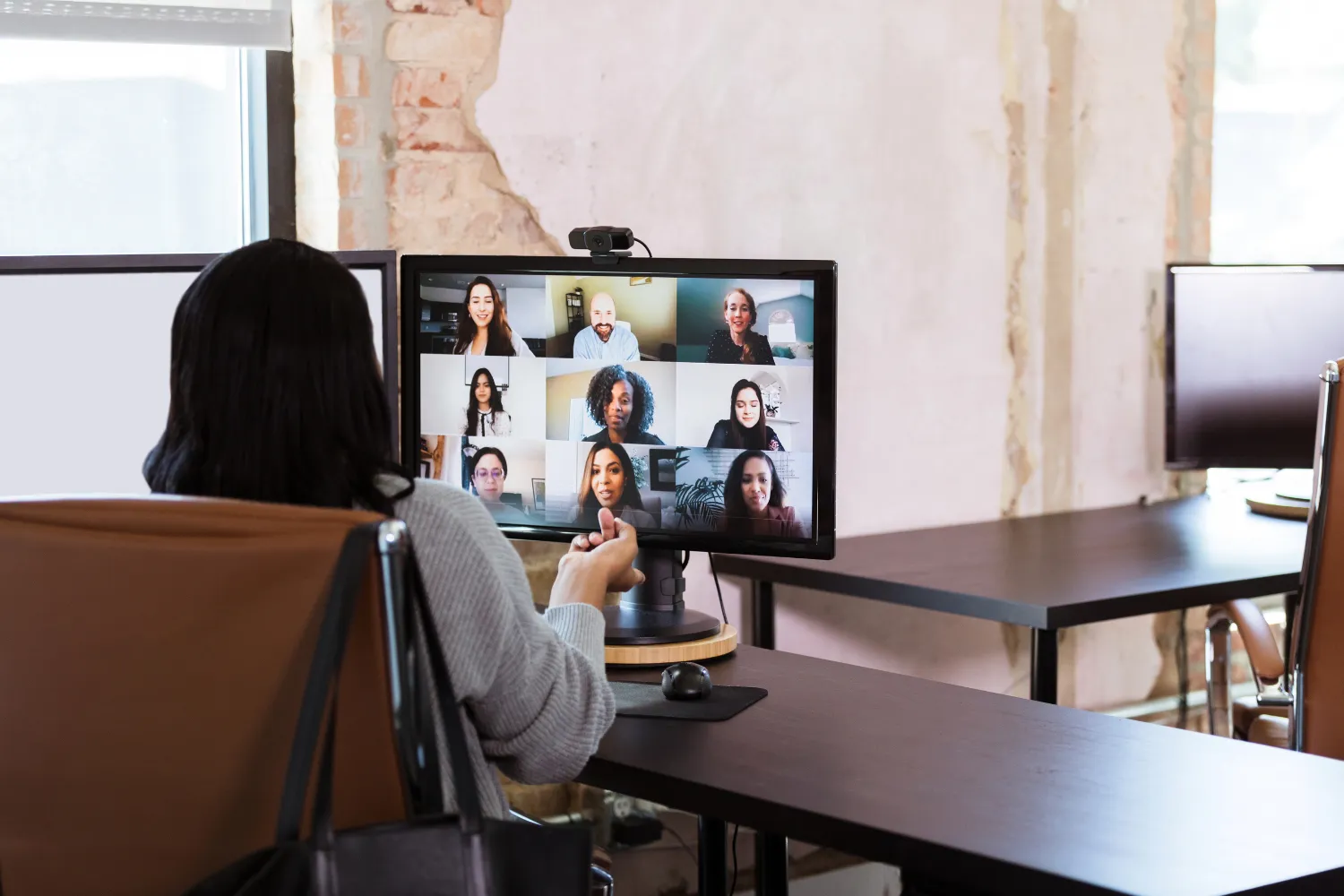 Woman on video meeting with other remote colleagues.