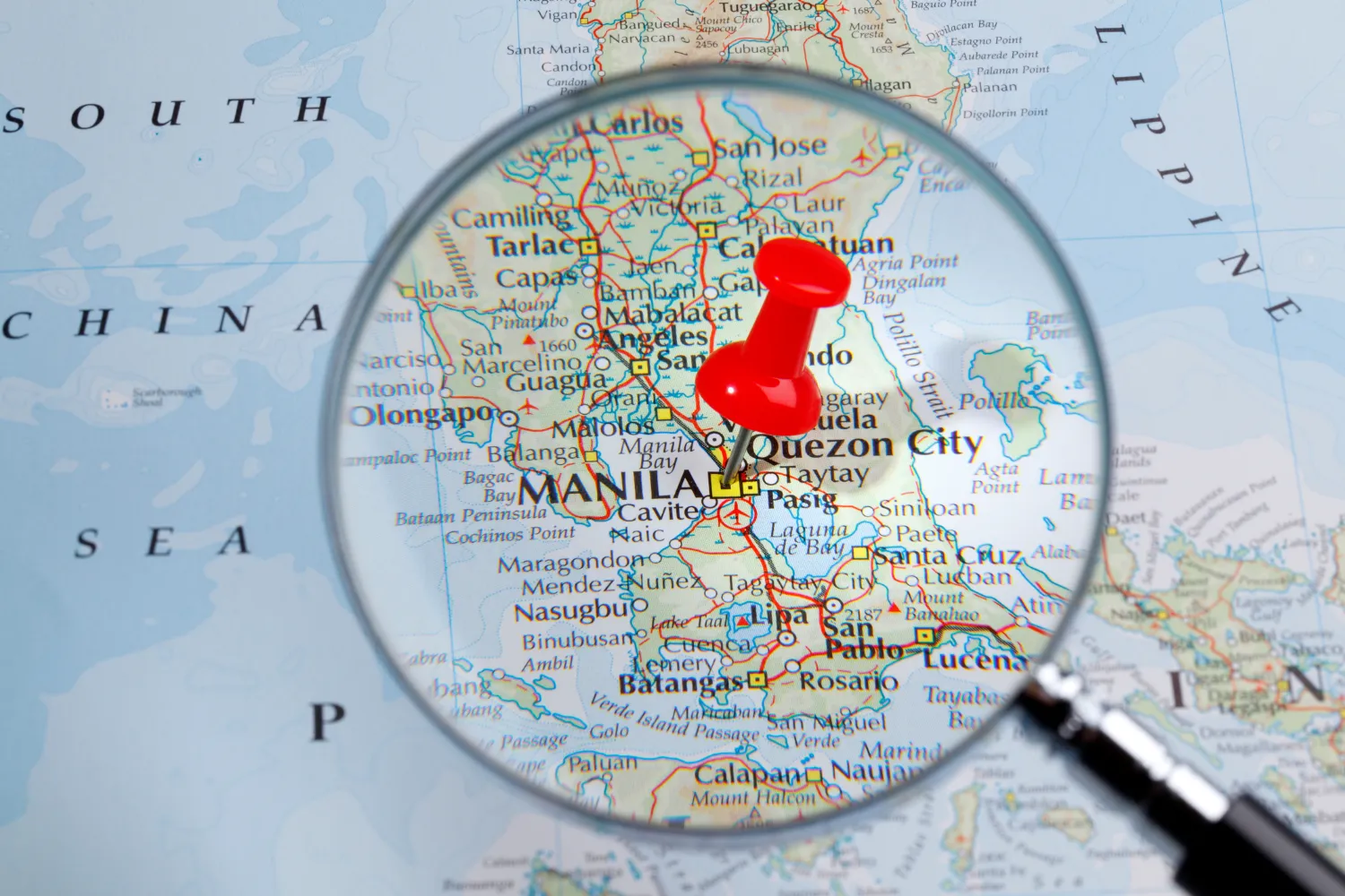 A map of the Philippines with a magnifying glass.