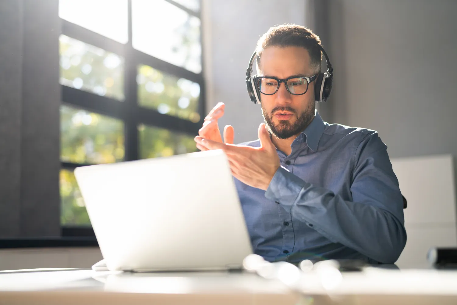 Employer with headset taking a quiz on his laptop.