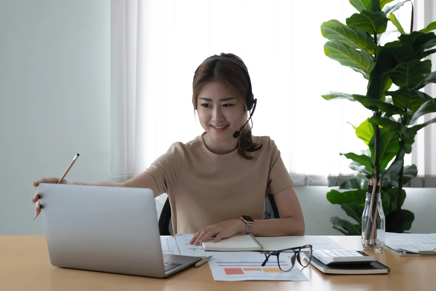 Remote worker smiling while working on laptop.