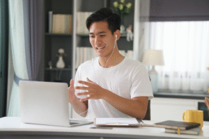 Filipino man speaking on a video call while working from home