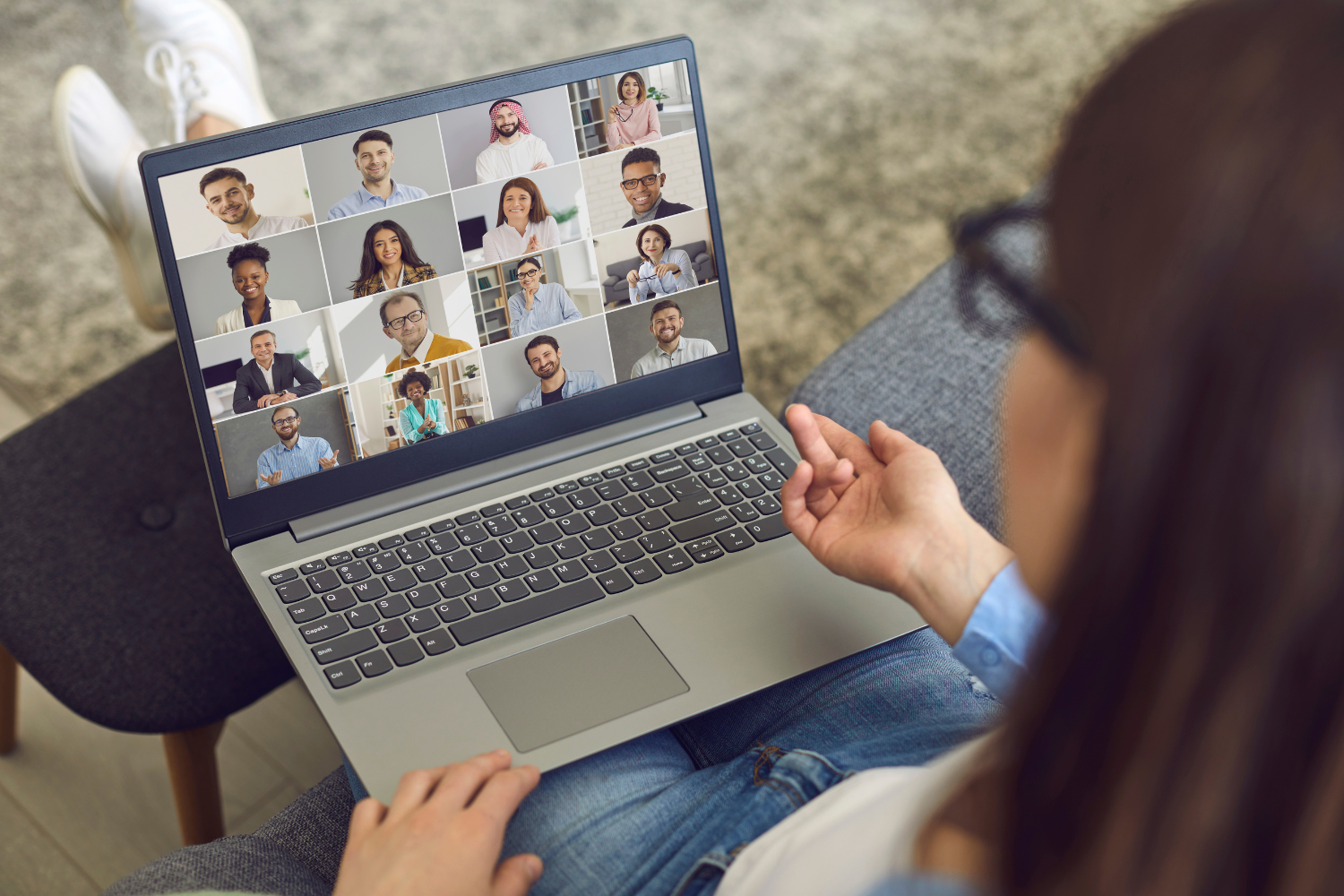 A Filipino remote worker talking to other coworkers through video conference.
