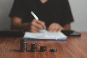 Person calculating costs on notebook.
