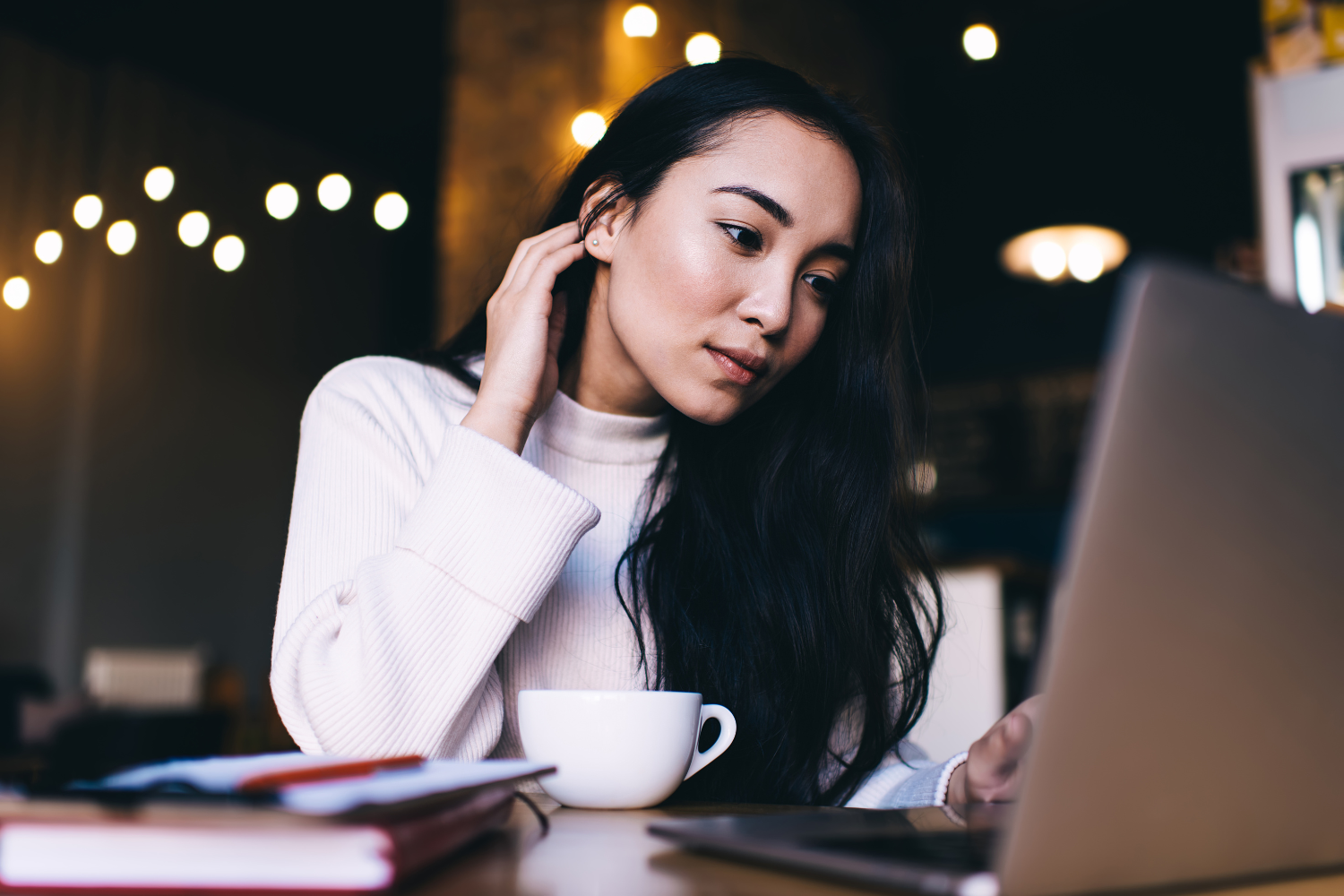 Remote employee working outside on her laptop.