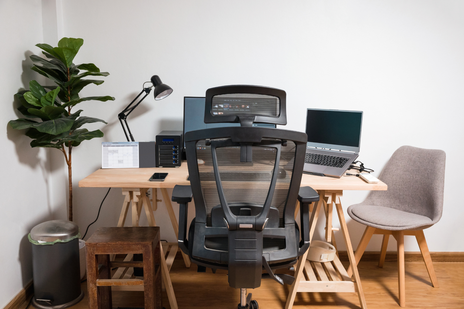 A home office with a proper desk, ergonomic chair, bright lighting, and minimal background noise.