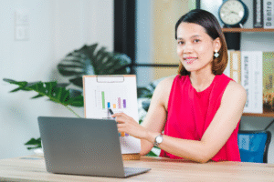 Filipina remote worker smiling on camera.