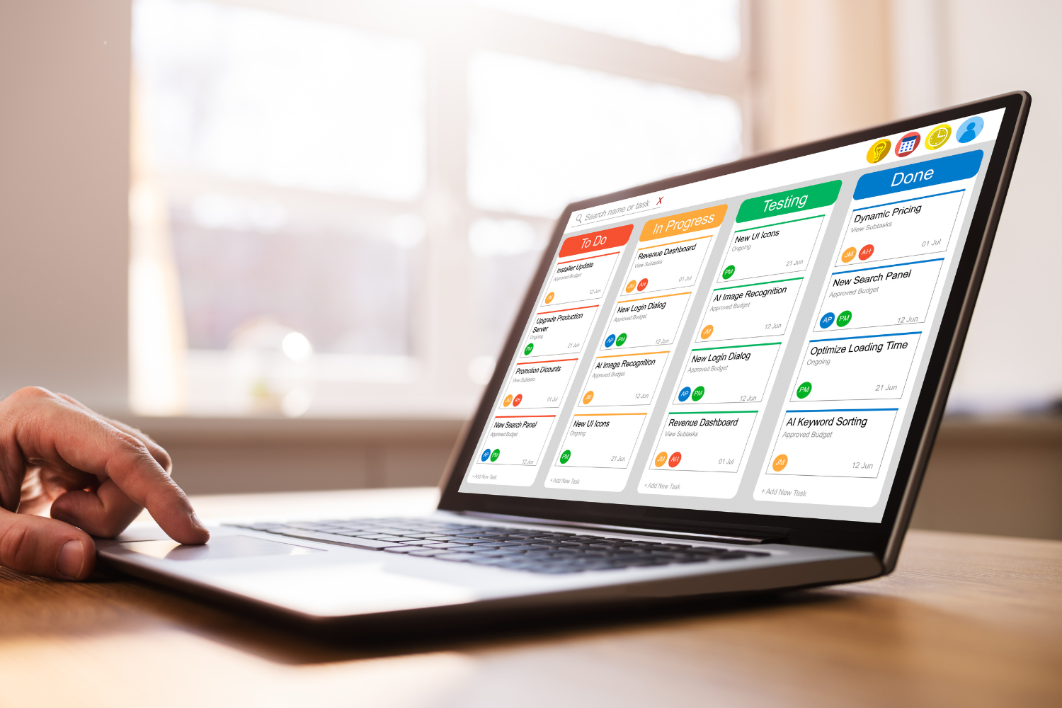 Project management software shown on laptop.